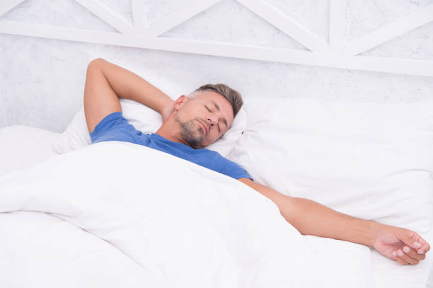 istock Tips sleeping better. Bearded peaceful man sleeping face relaxing on pillow covered blanket. Total relaxation. Healthy habits. Man handsome guy lay in bed sleeping. Get enough amount of sleep 1187562130