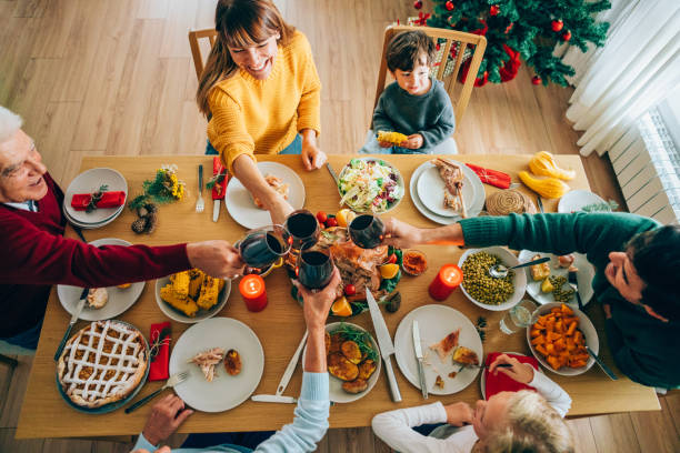 istock Family clinking glasses at Christmas dinner. 1187562896