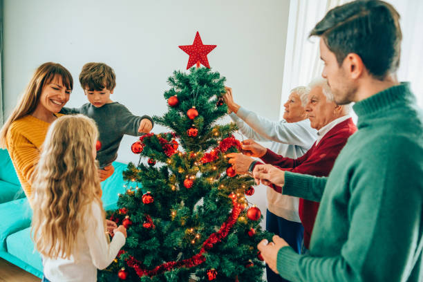istock Multi-generation family decorating the Christmas tree together 1187562958