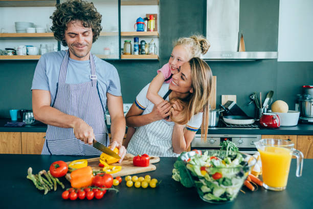 istock Young family having fun in the kitchen 1187563486