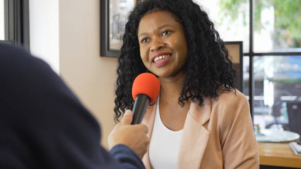 Media interview with African ethnicity businesswoman Media interview with African ethnicity businesswoman. media interview photos stock pictures, royalty-free photos & images