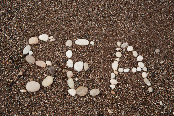 istock Sea message written on the beach, abstract background 1187564100
