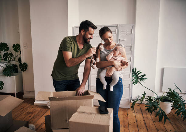 I found a toy you might like Cropped shot of an affectionate young father showing his young baby girl a stuffed toy while opening boxes in their new home on moving day young couple stock pictures, royalty-free photos & images