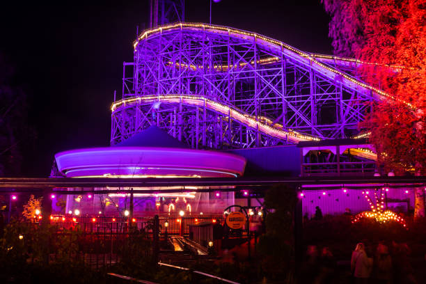 The Carnival of Light event at the Linnanmaki amusement park. Rides Karuselli and roller coaster Vuoristorata in motion. Night illumination, long exposure. Helsinki, Finland - 19 October 2019: The Carnival of Light event at the Linnanmaki amusement park. Rides Karuselli and roller coaster Vuoristorata in motion. Night illumination, long exposure. roller coaster line photos stock pictures, royalty-free photos & images