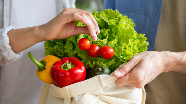 istock Young couple using fresh vegetables and zero waste shopping bag 1187572006