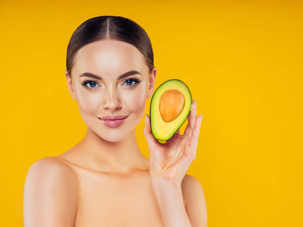 istock Beautiful girl with avocado 1187573039