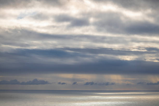 istock Dramatic cloudy blue sky over the ocean on a overcast day. 1187574164