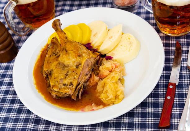Roasted quarter duck with red and white cabbage, bread and potato dumplings