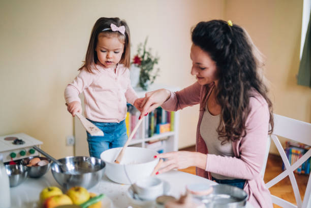 istock Happy mother and daughter in kitchen 1187576091