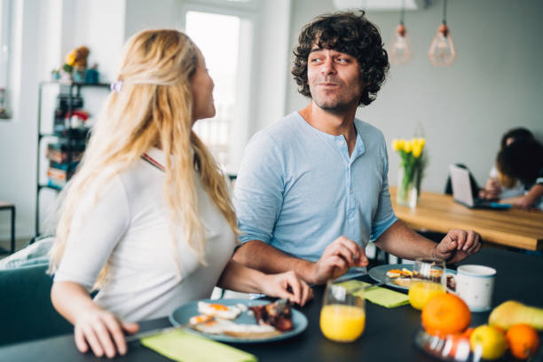 istock Happy couple enjoying breakfast together 1187576119