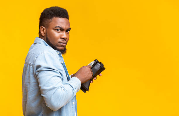 istock Suspicious african guy stole someone's wallet and counting his loot 1187576374