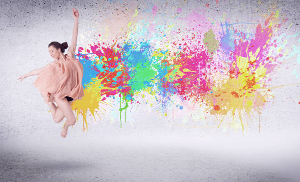 istock Modern street dancer jumping with colorful paint splashes 1187577532