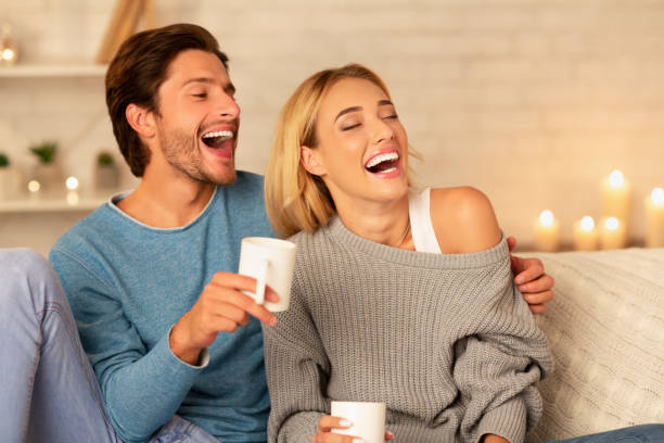 istock Boyfriend And Girlfriend Having Tea Sitting On Couch At Home 1187579292