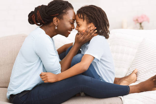 istock Happy african american mom embracing her daughter's face 1187579357