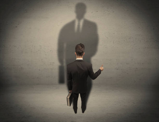 istock Businessman looking at big shadow concept 1187580276