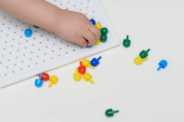 istock the baby plays with a mosaic sitting at a table 1187580930