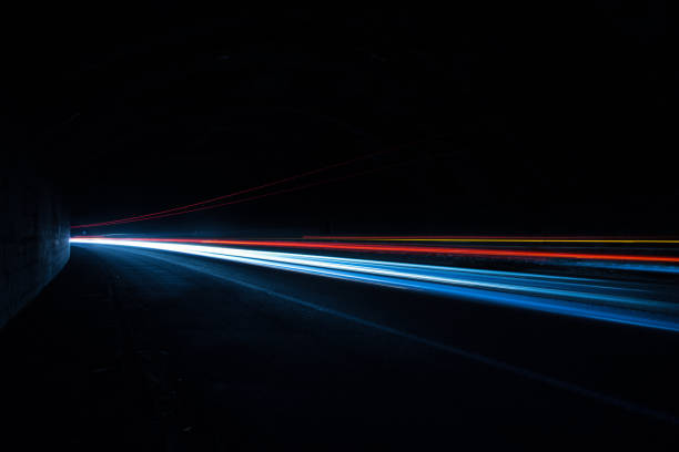 car light trails in a tunnel at night. art image - land vehicle in a row action motion imagens e fotografias de stock