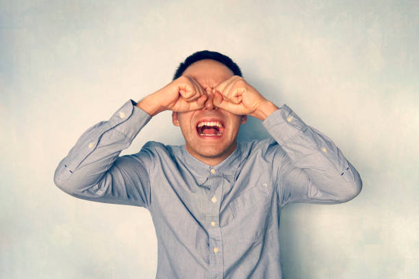 istock A grown man in a blue shirt screams and cries. Negative emotion. People react negatively to problems. crazy man crying 1187582569