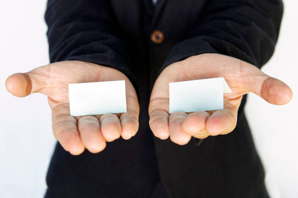 istock hands is holding a blue color papers with empty space for note. Offer choice of 2 options. 1187583443