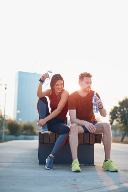 istock Modern couple making pause in an urban park during jogging / exercise. 1187583537