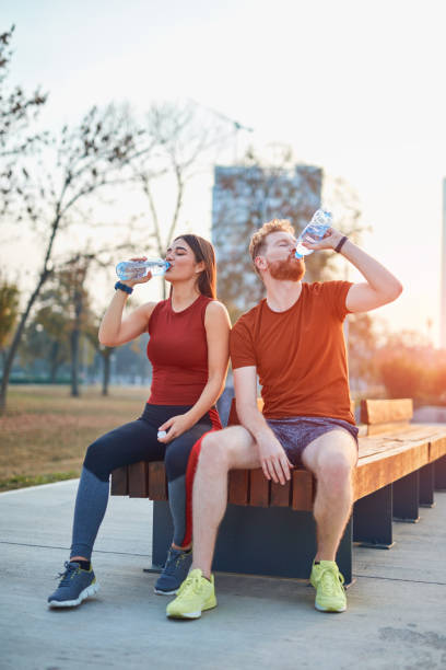 istock Modern couple making pause in an urban park during jogging / exercise. 1187583598