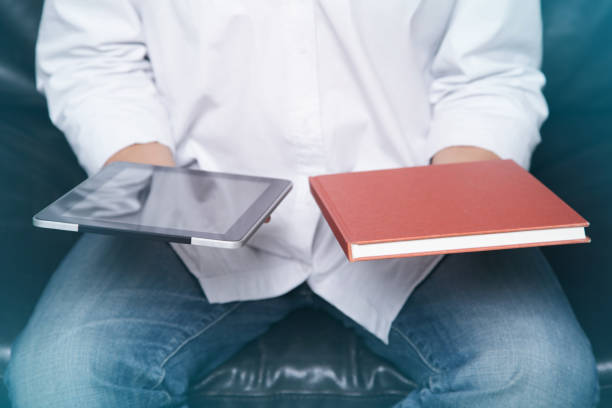 Man Holding a Digital Tablet and Book.