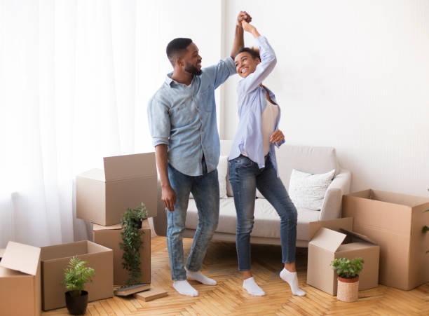 istock Black Couple Dancing Among Moving Boxes In New Home 1187583879