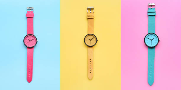 Set of multicolored wristwatches on colorful background