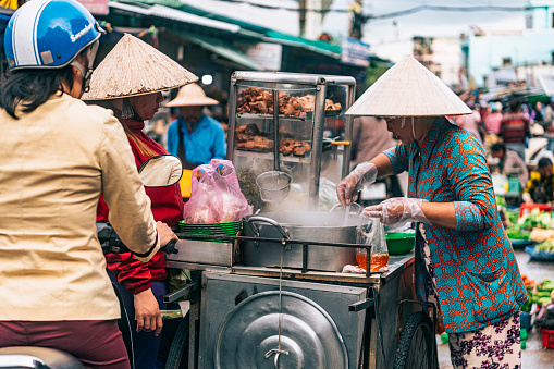 A woman serving customers at the morning Duong Dong Market in Phu Quoc, Vietnam