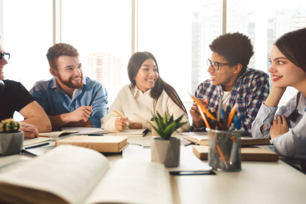 istock Happy classmates having break in college library 1187586323