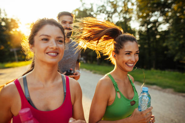 istock Three young people jogging together in nature 1187586519