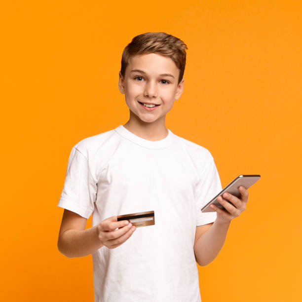 istock Cute teenager using mobile application and credit card 1187586576