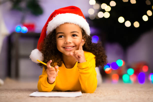 istock Cute african girl has great thought about Christmas gift 1187587208