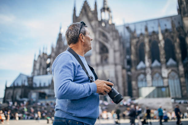 istock An elderly man photographing a tourist destination with a digital camera 1187587613