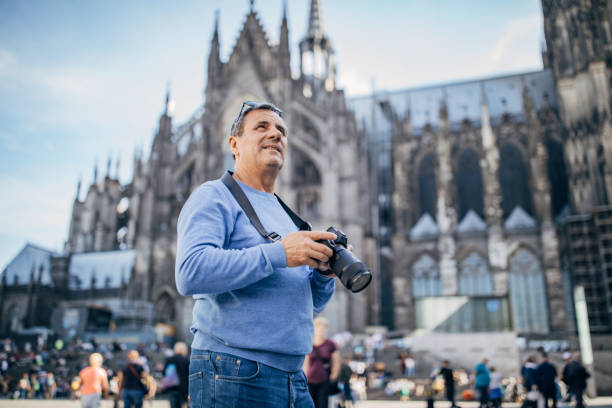 istock An elderly man photographing a tourist destination with a digital camera 1187587619
