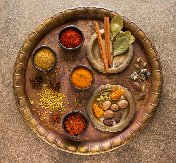 selection indian spices and seasonings in bowls on a metal tray, top view - cardamom cinnamon mortar and pestle herb imagens e fotografias de stock
