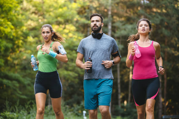 istock Friends jogging together in nature 1187590045