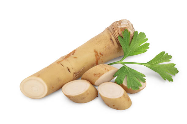 istock Horseradish root with slices and parsley isolated on white background 1187591723