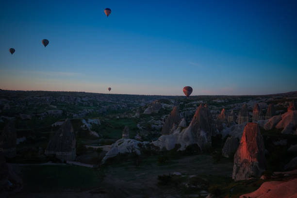 Sunrise panoramic view to Goreme city and flying balloons, Cappadocia, Turkey Sunrise panoramic view to Goreme,Uchisar city and flying balloons over pigeon valley Cappadocia, Turkey niğde city stock pictures, royalty-free photos & images