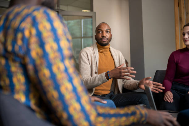 istock Creative black businessman talking in interview casually with fellow diverse South African coworkers 1187593697