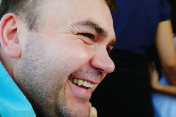 Venice, Italy - 27 October, 2019: caucasian man face profile close-up - he is laughing, happy, cheerful