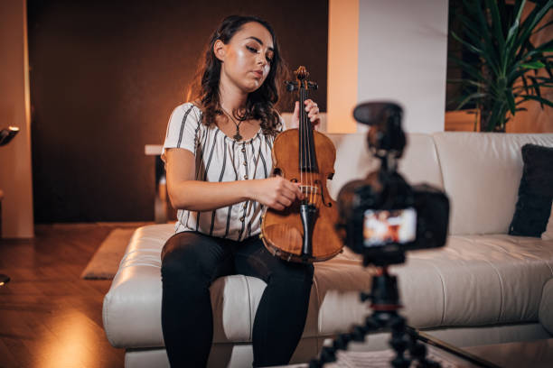 istock Lady violinist vlogging at home 1187596915