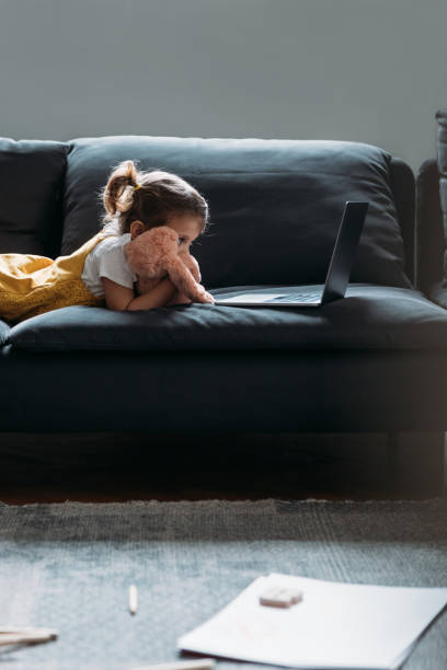 istock Little Girl Looking at Laptop 1187599036