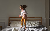 Little Girl Jumping on a Bed
