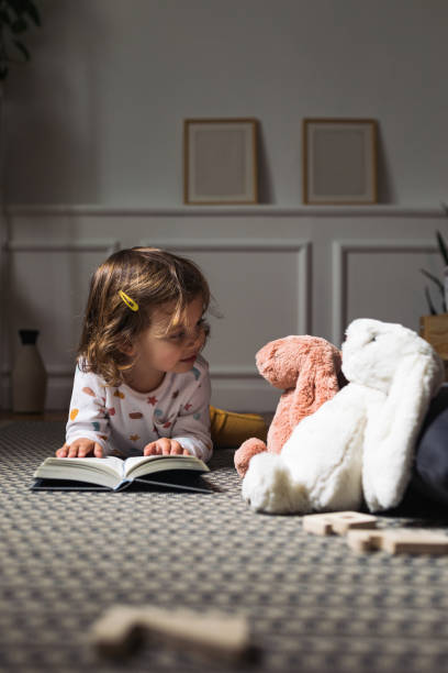 istock Little Girl Reading a Book 1187599103