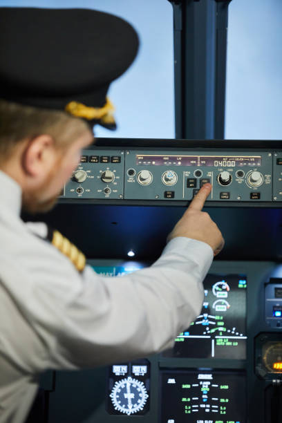 istock Captain of aircraft pushing button 1187603928