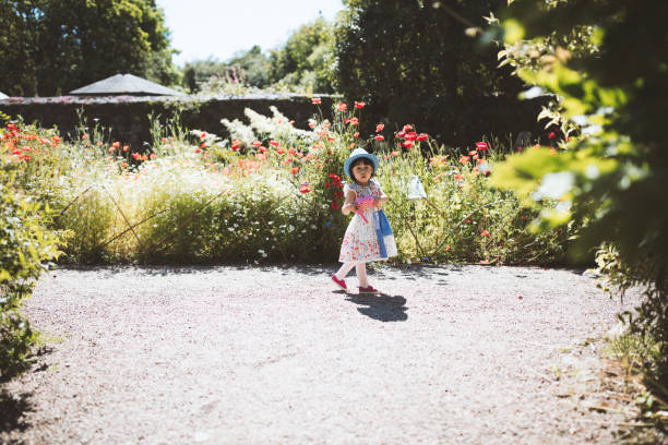 istock Cute Girl Standing By Plants 1187608889