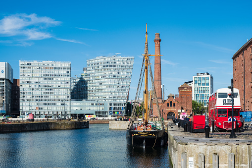 Liverpool, United Kingdom - July 18, 2019: Old industrial warehouses and modern office buildings around the waters of Canning Dock in Liverpool's rennovated docklands