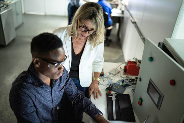 istock Colleagues working together and using laptop in industry 1187612223