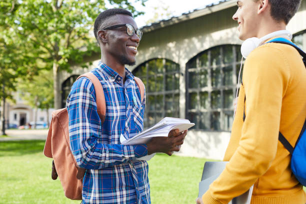 istock Smiling College Students Chatting Outdoors 1187612515